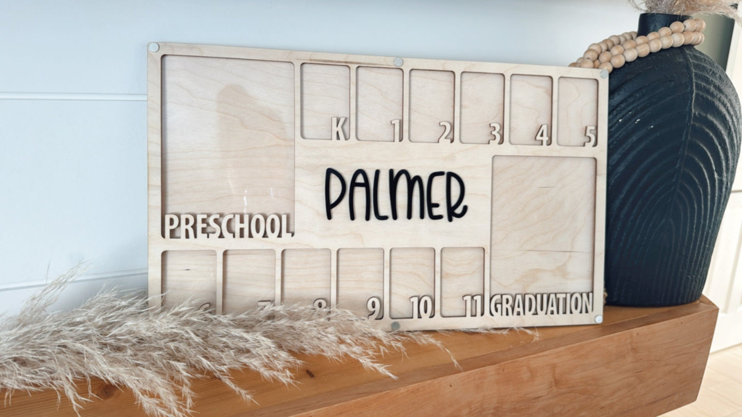 Wooden nameplate with engraved text on a light blue wall.